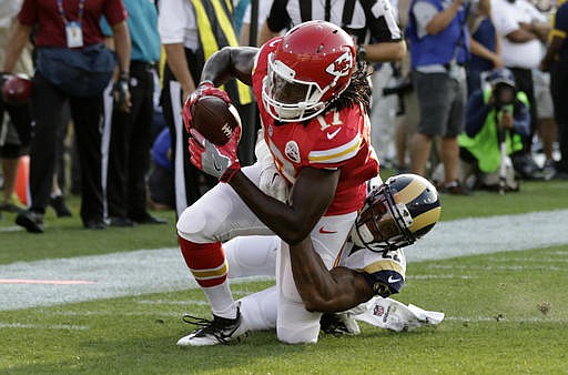Kansas City Chiefs wide receiver Chris Conley, top, is dragged down Los Angeles Rams cornerback Trumaine Johnson during the first half of a preseason NFL football game, Saturday, Aug. 20, 2016, in Los Angeles. 