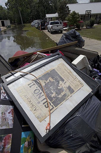 The personal belonging of a flood damaged home is piled on the road side waiting for garbage pick up in St. Amant, La., Saturday, Aug. 20, 2016. Louisiana continues to dig itself out from devastating floods, with search parties going door to door looking for survivors.