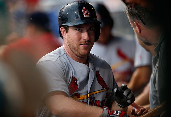 Jedd Gyorko of the Cardinals is congratulated in the dugout after hitting a two-run home run in the eighth inning of Sunday's game against the Phillies in Philadelphia.