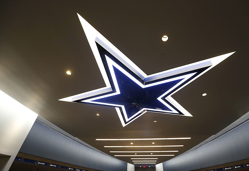 A lighting fixture of the Dallas Cowboys logo is seen in the locker room Sunday at the Dallas Cowboys' new headquarters at The Star in Frisco, Texas. 