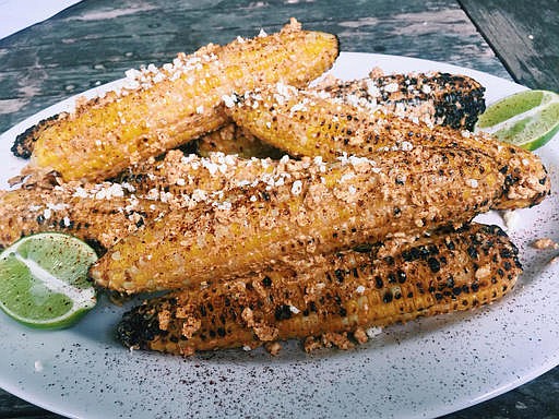 This July 2016 photo shows Mexican grilled corn in New Milford, Conn. This dish is from a recipe by Katie Workman.