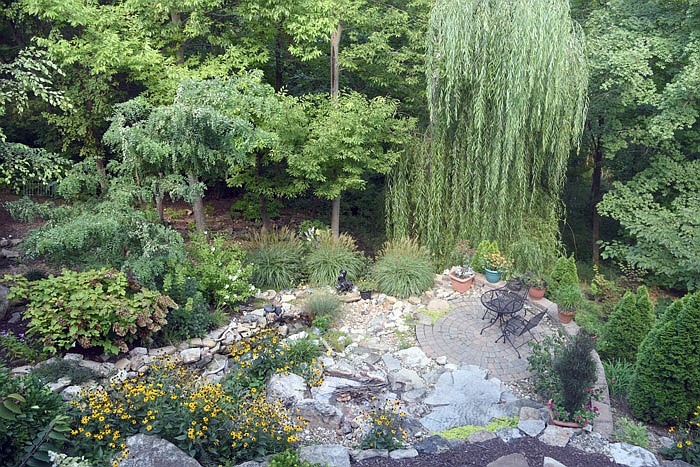 Millie and Tom Jones' Summer Way backyard features various trees, flowers and a water feature. The couple won the Garden of the Month award for August. 