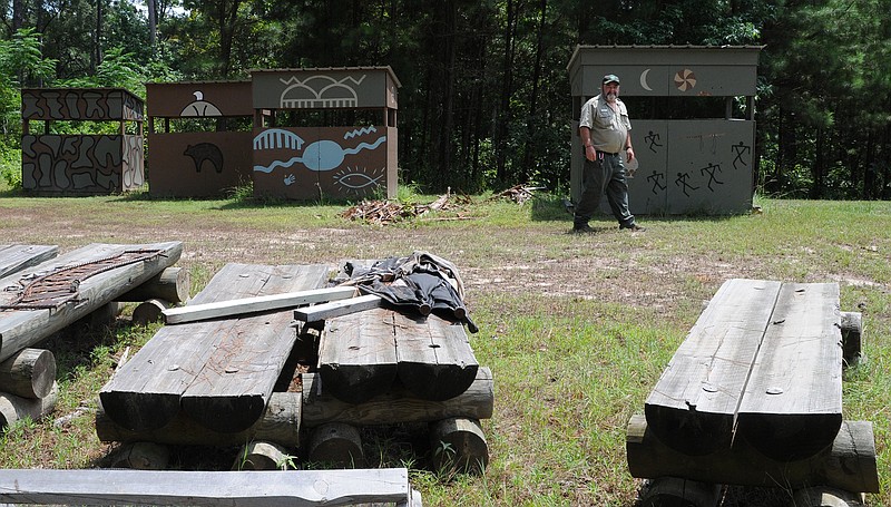 Atlanta State Park ranger Roger Moulton has built 10 deer stands to be placed throughout the park. They are covered with authentic American Indian sign language. The wooden logs in the foreground are benches saved from park's theater grounds that had floated away in the flooding.
