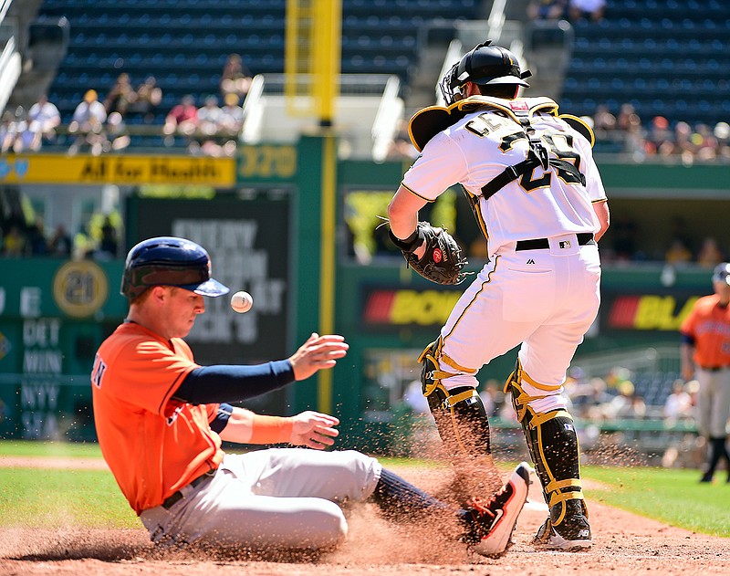 Houston Astros' Alex Bregman slides safely into home as Pittsburgh Pirates' Francisco Cervelli awaits a late throw in the fifth inning of a baseball game in Pittsburgh, Wednesday, Aug. 24, 2016. 