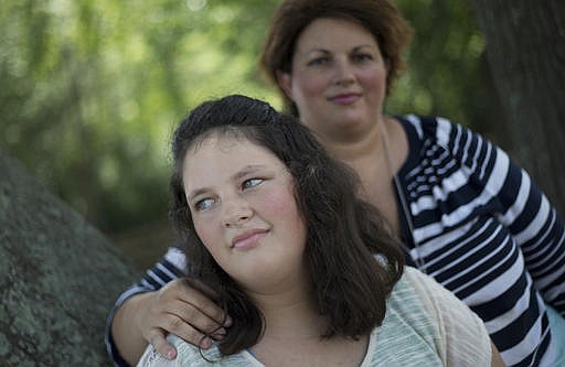 In this July 22, 2016 photo, Kaley Zacher poses for a portrait with her mother Kimberly, in Dublin, Ga. Zacher gave permission for Kaley to be paddled twice at Southwest Laurents Elementary School, Ga. Although the use of corporal punishment in American schools has declined in recent decades, paddling is still on the books in 19 states, despite calls from the U.S. Education Department to curb punitive disciplinary measures, which has been shown to affect minority and disabled students disproportionately.
