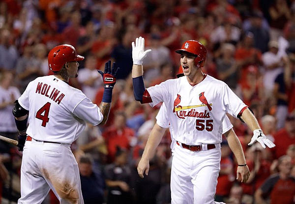 Cardinals outfield Stephen Piscotty (right) is congratulated by teammate Yadier Molina after hitting a two-run home run during the fifth inning of Wednesday night's game against the Mets in St. Louis