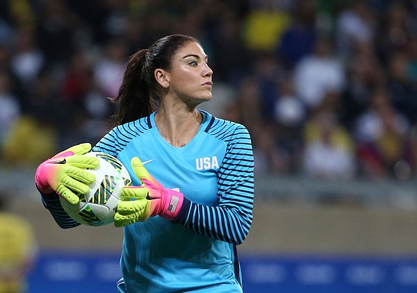 In this Aug. 3 file photo, U.S. goalkeeper Hope Solo takes the ball during a women's Olympic soccer match against New Zealand in Belo Horizonte, Brazil. Solo has been suspended from the team for six months.