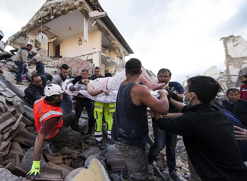 A rescued woman is carried away on a stretcher following an earthquake in Amatrice Italy, Wednesday, Aug. 24, 2016.  The magnitude 6 quake struck at 3:36 a.m. (0136 GMT) and was felt across a broad swath of central Italy, including Rome where residents of the capital felt a long swaying followed by aftershocks. 