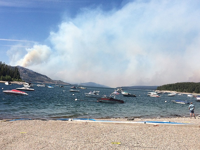 Smoke fills the sky in a view north toward Yellowstone National Park from Leeks Marina in Moose, Wyo., on Tuesday, Aug. 23, 2016. Visitors headed north are being stopped at Leeks. In neighboring Yellowstone, a fire grew near West Entrance Road. A team of fire managers was being brought in to help, although the fire was not yet being actively suppressed.