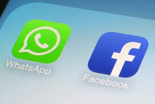 This Feb. 19, 2014, file photo, shows WhatsApp and Facebook app icons on a smartphone in New York. 