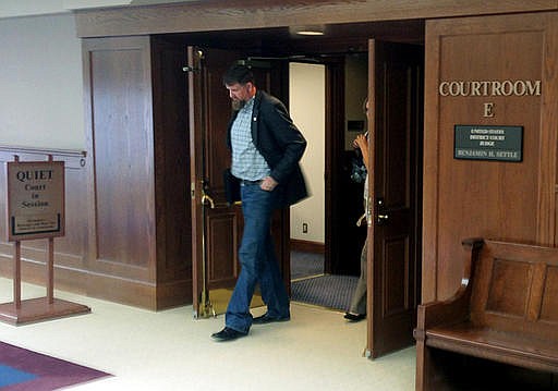 Former National Guard soldier Darryl Lee Wright leaves a courtroom at the U.S. District Court in Tacoma, Wash., where he faced two fraud charges Thursday, Aug. 25, 2016. Federal prosecutors say Wright lied his way to a Purple Heart and hundreds of thousands of dollars in government benefits.