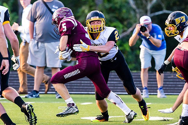 Fulton linebacker Ben Bader tries to bring down School of the Osage running back Dylan Brown during the Hornets' 28-21 loss last Friday night to the Indians at Osage Beach.
