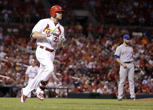 St. Louis Cardinals' Brandon Moss, left, rounds the bases after hitting a two-run home run off New York Mets relief pitcher Jim Henderson during the sixth inning of a baseball game Thursday, Aug. 25, 2016, in St. Louis.