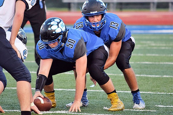 South Callaway junior quarterback Landon Horstman lines up under senior center Braeden Sconce during the Bulldogs' victory against Father Tolton in last week's season opener at Mokane.