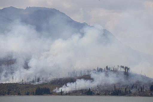 The Berry Fire burns off the shore of Jackson Lake in Grand Teton National Park, Wyo., Thursday, Aug 25, 2016. Thursday, Aug 25, 2016 marks the 100th anniversary of the U.S. National Park Service. 