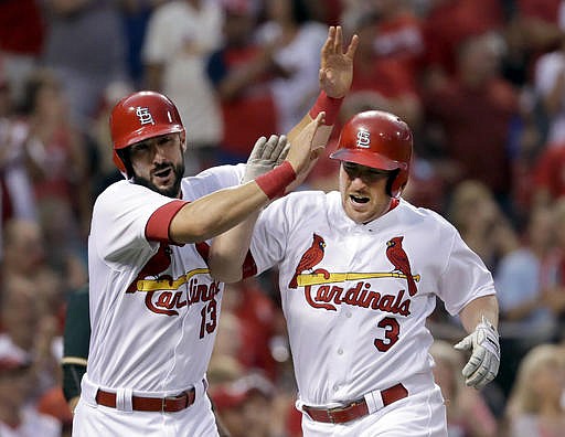 St. Louis Cardinals' Jedd Gyorko, right, is congratulated by teammate Matt Carpenter after hitting a two-run home run during the first inning of a baseball game against the Oakland Athletics, Friday, Aug. 26, 2016, in St. Louis. 