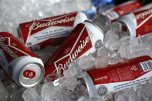 In this Thursday, March 5, 2015, file photo, Budweiser beer cans are seen at a concession stand at McKechnie Field in Bradenton, Fla.