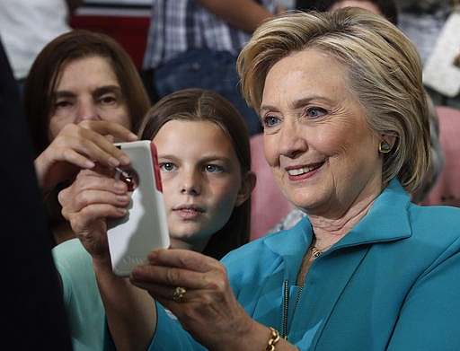 Democratic presidential candidate Hillary Clinton takes cellphone photos with people in the audience at a campaign event at Truckee Meadows Community College in Reno, Nev., Thursday, Aug. 25, 2016.