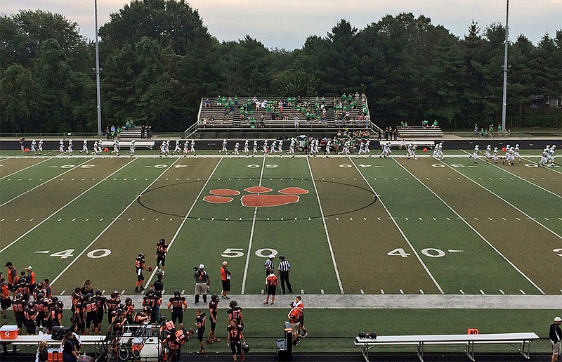 Blair Oaks (along far sideline) takes the field at Oak Grove in advance of their high school football game on Friday, Aug. 26, 2016. Blair Oaks won 28-20.