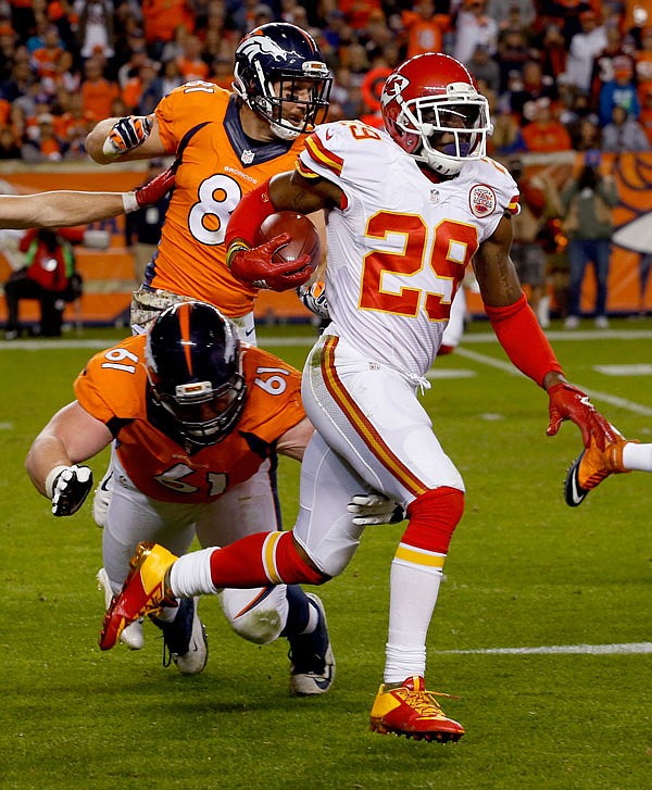 In this Nov. 15, 2015, file photo, Chiefs free safety Eric Berry runs back an interception during the second half a game against the Broncos in Denver. A person familiar with Eric Berry's plans said the All-Pro safety will report to practice Sunday.