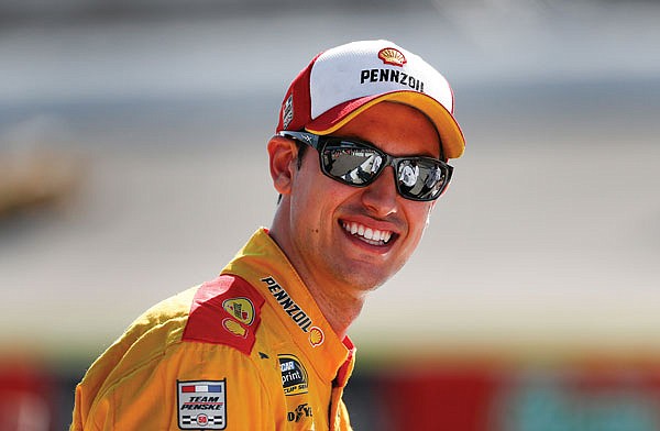 Joey Logano smiles during qualifications Friday at Michigan International Speedway in Brooklyn, Mich.