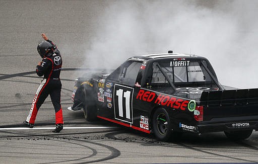 Brett Moffitt celebrates winning the NASCAR Camping World Truck Series auto race at Michigan International Speedway, in Brooklyn, Mich., Saturday, Aug. 27, 2016. 