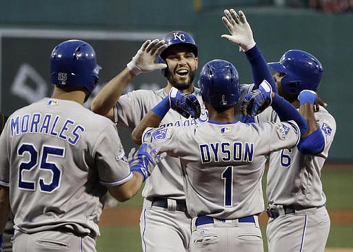 Kansas City Royals' Eric Hosmer, center, celebrates his three-run home run with Jarrod Dyson (1), Lorenzo Cain (6) and Kendrys Morales (25) in the first inning of a baseball game against the Boston Red Sox at Fenway Park, Friday, Aug. 26, 2016, in Boston. 