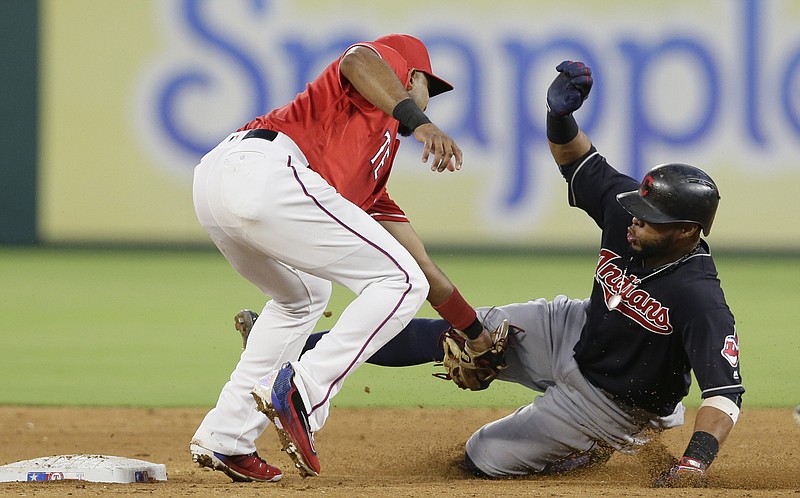 Cleveland Indians Carlos Santana, right, is tagged out by Texas Rangers shortstop Elvis Andrus at second base while trying to steal during the third inning of a baseball game in Arlington, Texas, Saturday, Aug. 27, 2016.