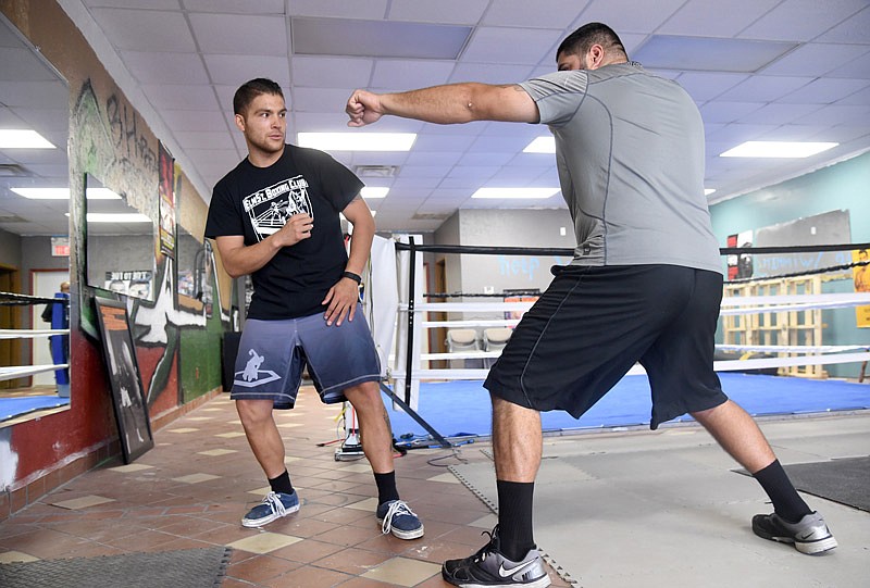 Owner Mario Antonio, left, trains Ramon Barraza on Wednesday at ElmSt. Boxing Club. Antonio, originally from East Los Angeles, was a boxer before he moved to Jefferson City.