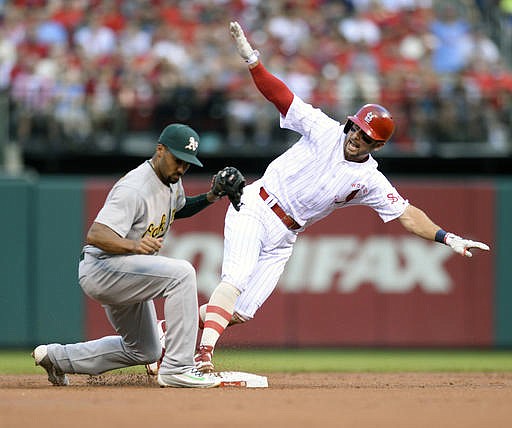 St. Louis Cardinals' Greg Garcia (35) slides safety into second base to beat the tag by Oakland Athletics shortstop Marcus Semien (10) for a lead off double during the first inning of a baseball game Saturday, Aug. 27, 2016, in St. Louis.