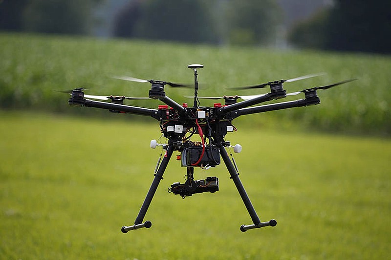 A hexacopter drone is flown during a drone demonstration at a farm and winery on potential use for board members of the National Corn Growers in Cordova, Maryland. NASA is entering the next phase of a plan to draw up rules of the road for small drones that fly under 500 feet.