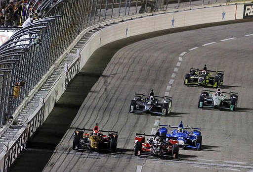 Graham Rahal, center, edges out James Hinchcliffe, left, at the checkered flag to win the IndyCar auto race at Texas Motor Speedway, Saturday, Aug. 27, 2016, in Fort Worth, Texas. 