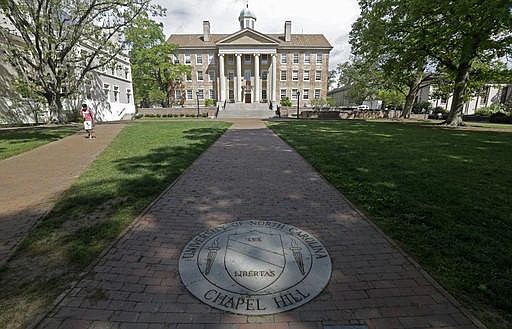 In this April 20, 2015, file photo, a sidewalk leads to the South Building on campus at The University of North Carolina in Chapel Hill, N.C. A federal judge ruled Friday, Aug. 26, 2016, that two students and an employee must be allowed to use restrooms matching their gender identity at University of North Carolina campuses, and he said they have a strong chance of proving the state's bathroom-access measure violates federal law, a judicial rebuke that transgender rights advocates hailed as a victory. 