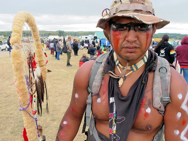 Jon Don Ilone Reed, an Army veteran and member of South Dakota's Cheyenne River Sioux Tribe, poses for a photo at an oil pipeline protest near the Standing Rock Sioux reservation in southern North Dakota, Thursday, Aug. 25, 2016. Reed said he fought in Iraq and is now fighting "fighting for our children and our water." 
