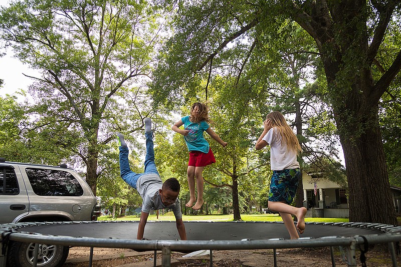 Christien Hayes, 9, Zoey Arnold, 9, and Cassie Arnold, 10, jump on a trampoline Sunday in Texarkana, Texas. The friends like to jump and come up with names for tricks. 