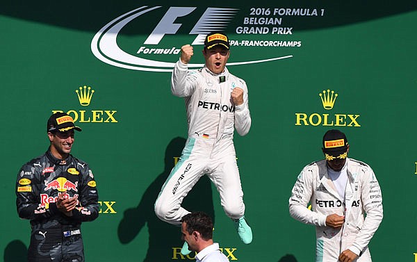 Mercedes driver Nico Rosberg (center) celebrates on the podium with Red Bull driver Daniel Ricciardo (left) and Mercedes driver Lewis Hamilton (right) after winning the Belgian Formula One Grand Prix on Sunday in Spa-Francorchamps, Belgium.