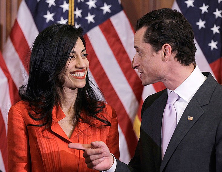 Then-New York Rep. Anthony Weiner and his wife, Huma Abedin, an aide to then-Secretary of State Hillary Clinton, are pictured after a 2011 ceremonial swearing in of the 112th Congress on Capitol Hill. Abedin said Monday she is leaving Weinter after his latest sexting scandal.