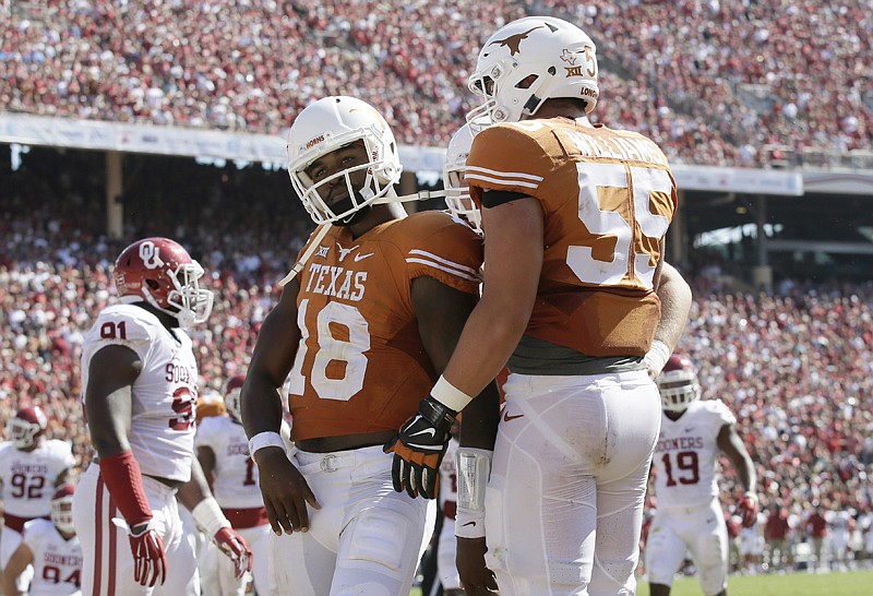 Texas quarterback Tyrone Swoopes celebrates his touchdown with offensive lineman Connor Williams against Oklahoma on Oct. 10, 2015, in Dallas. 