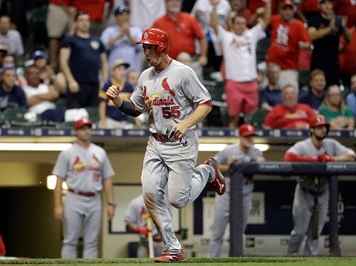 Stephen Piscotty of the Cardinals scores the game-winning run Monday night in Milwaukee.