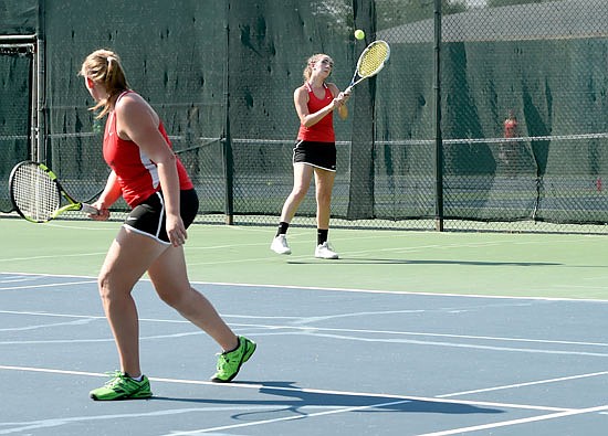 Susan Meyer of the Jefferson City Lady Jays makes a backhand return as teammate Erica Dunn watches during a doubles match Monday, Aug. 24, 2016 against Waynesville at Washington Park in Jefferson City.
