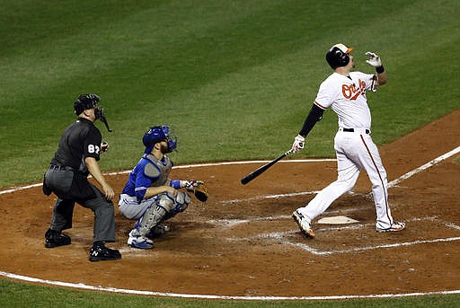 Baltimore Orioles' Matt Wieters, right, watches his two-run home run in front of Toronto Blue Jays catcher Russell Martin and home plate umpire Scott Barry in the eighth inning of a baseball game in Baltimore, Tuesday, Aug. 30, 2016. Baltimore won 5-3. 