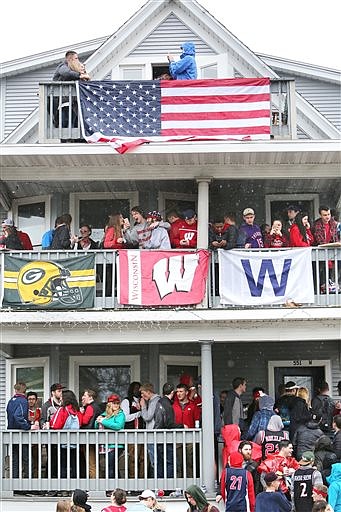 In this April 30, 2016, photo, people stand on porches and balconies at a home on Mifflin Street during the annual block party in Madison, Wis. The Princeton Review's 2017 edition of the "The Best 381 Colleges" said Monday, Aug. 29, 2016, that the University of Wisconsin-Madison is the nation's top party school, followed by West Virginia and the University of Illinois. (Amber Arnold/Wisconsin State Journal via AP)