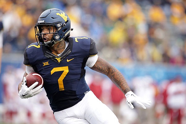 West Virginia running back Rushel Shell carries the ball during a game last season against Iowa State in Morgantown, W. Va.