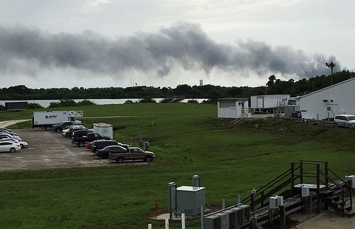 Smoke rises from a SpaceX launch site Thursday at Cape Canaveral, Florida. NASA said SpaceX was conducting a test firing of its unmanned rocket when a blast occurred. 