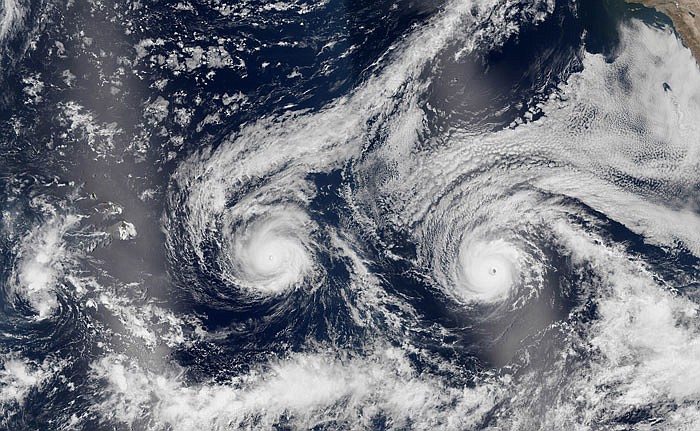 This satellite image taken Monday shows Hurricane Madeline, left, and Hurricane Lester over the Pacific Ocean in a composite built from two overpasses by the Visible Infrared Imaging Radiometer Suite on the Suomi NPP satellite. 