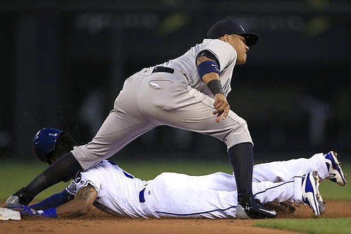 Kansas City Royals' Jarrod Dyson, bottom, beats the tag by New York Yankees second baseman Starlin Castro during the second inning of a baseball game at Kauffman Stadium in Kansas City, Mo., Wednesday, Aug. 31, 2016. Dyson was safe at second with a stolen base on the play. 