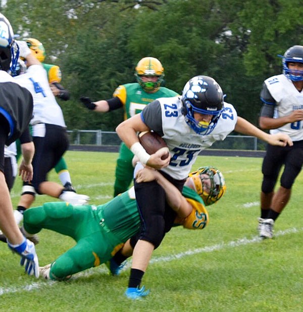 South Callaway junior running back Kaden Helsel drags a Milan defender behind him during the Bulldogs' 39-0 win on Friday, Aug. 26, 2016 in Milan, Mo.