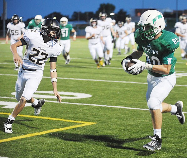 Blair Oaks wide receiver Ben Thomas (right) races past Versailles defensive back Brayden Morrison as he makes his way to the end zone for a 25-yard touchdown reception during the second quarter Friday night at the Falcon Athletic Complex.