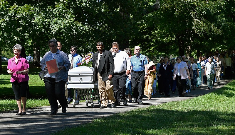 The casket containing the remains of Sister Paula Merrill, leads the processional into the cemetery following her funeral service, Friday, Sept. 2, 2016, at St. Vincent Church in Bardstown, Ky. Sister Merrill, with the Sisters of Charity of Nazareth and another nun were found murdered in their home on Aug. 25 in Durant, Miss.