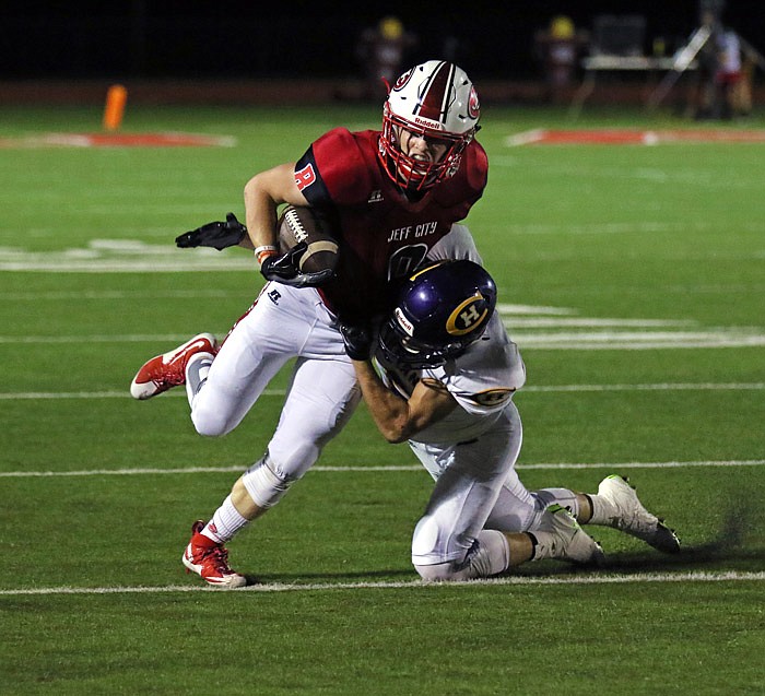 Jefferson City running back Tyler Bise is tackled by Hickman defensive back Devin Kottwitz during their game on Friday, Sept. 2, 2016 at Adkins Stadium.